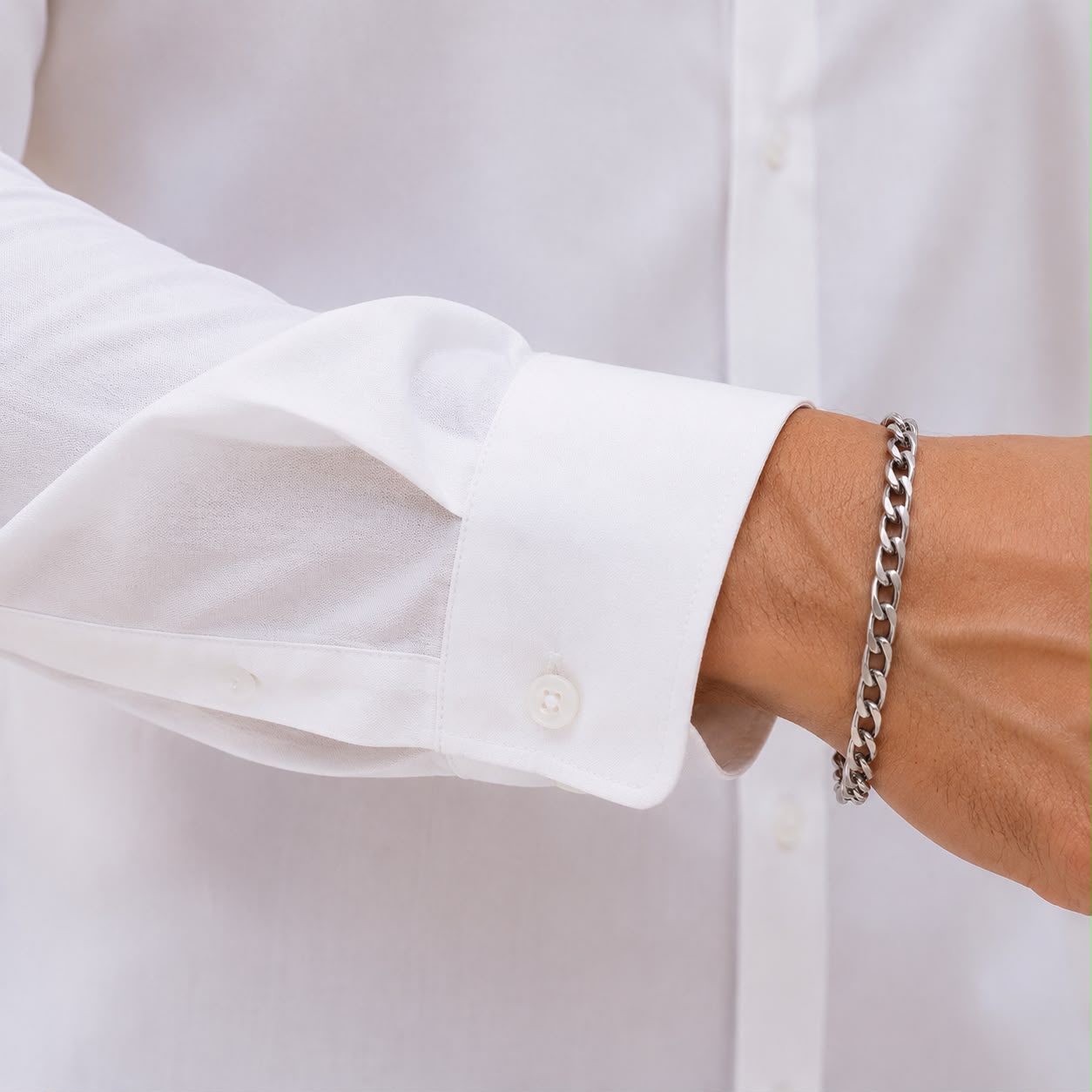 Close-up of Laxurine white cotton shirt sleeve and cuff detail